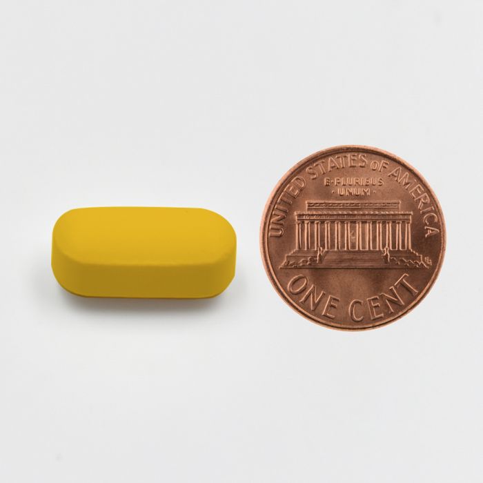 Yellow rectangular object next to a U.S. penny on a white background