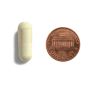 Two pills and a penny for size comparison.