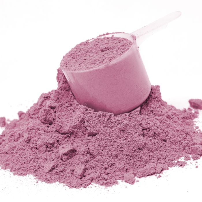 Pink sand with a scoop on a white background
