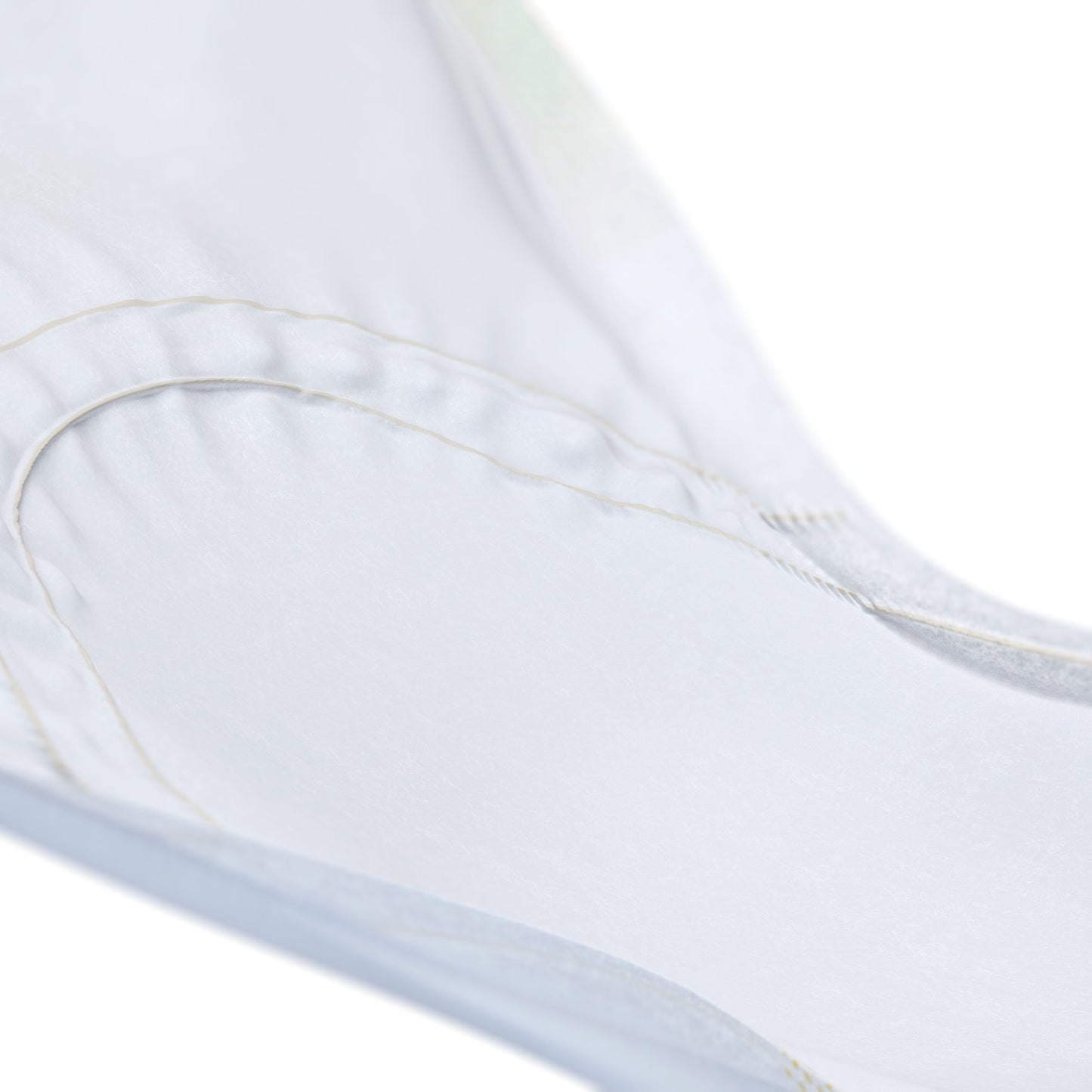 Close-up of a white fabric with a subtle pattern on a light background