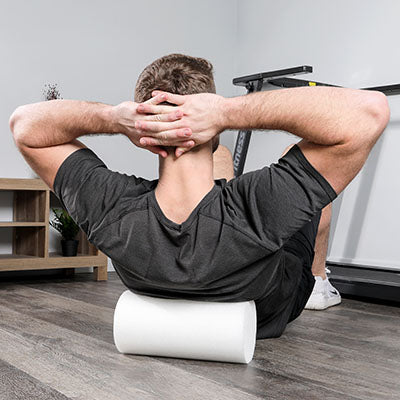 A man demonstrating the use of the foam roller.