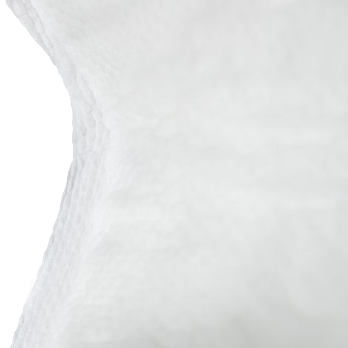 Close-up of a white textured pad on a light gray background