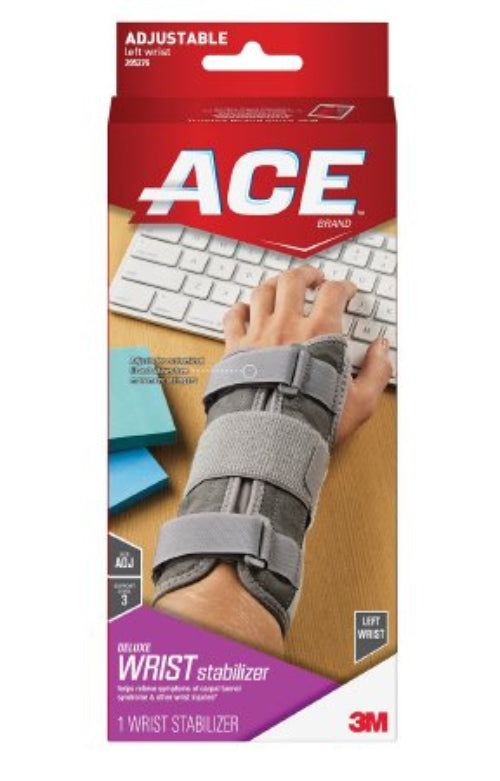A wrist brace designed for the left hand, featuring adjustable straps and cushioned padding, displayed in packaging.
