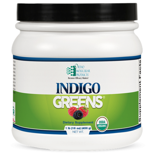 A container of Orthomolecular Products Indigo Greens Powder, which is a dietary supplement designed to provide a full-spectrum of superfoods including organic berries, vegetables, and greens.