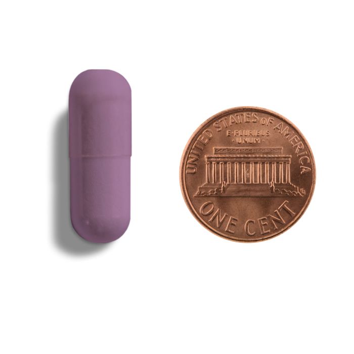 Purple lip balm next to a U.S. penny on a white background