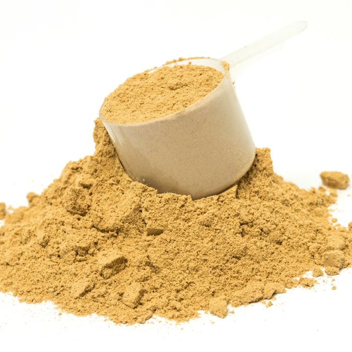 Brown powder in a small container on a white background