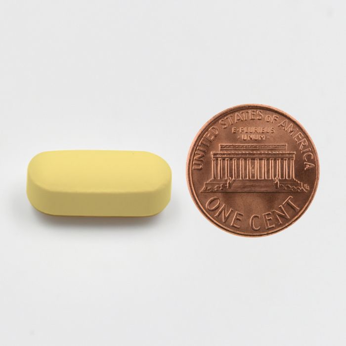 Yellow rectangular object next to a U.S. penny on a white background