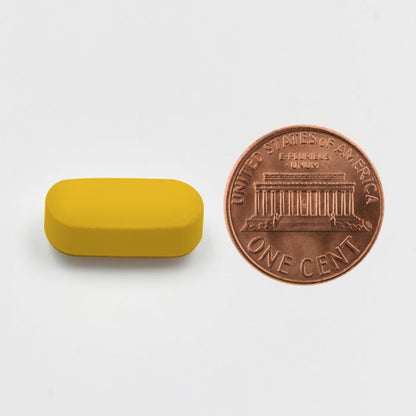 Yellow rectangular object next to a U.S. penny on a white background