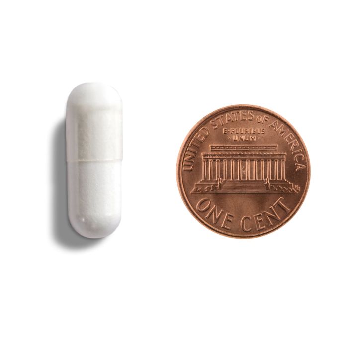 White earbud and copper penny on a white background