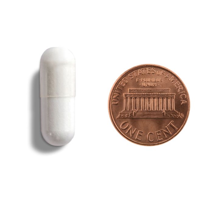 White cylindrical object next to a copper penny on a white background