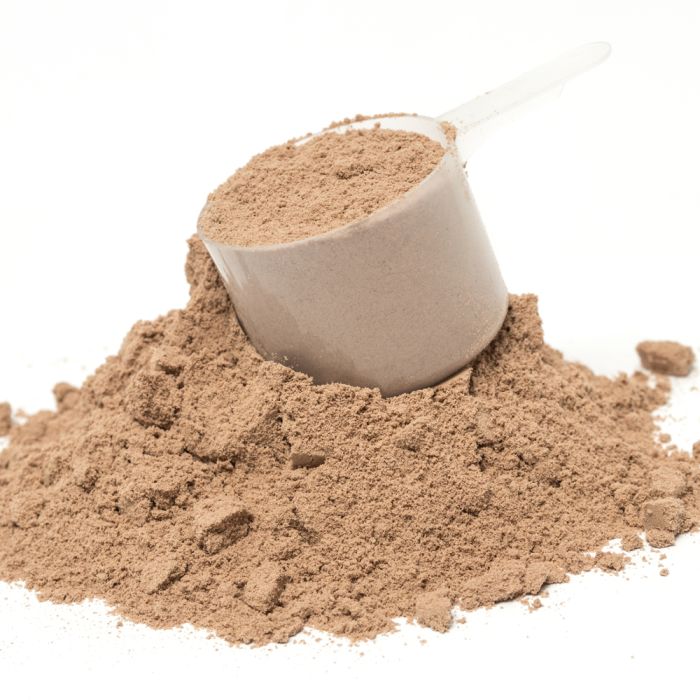 Beige powder in a scoop on a white background