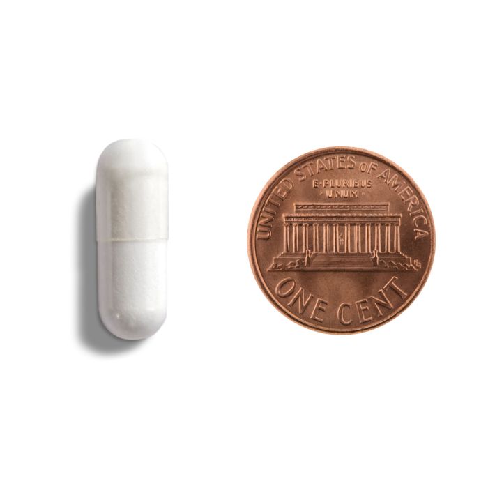 White cylindrical object next to a copper penny on a white background