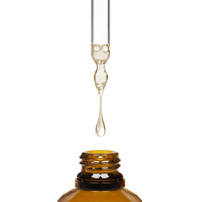Amber glass dropper bottle with a droplet of liquid on a white background
