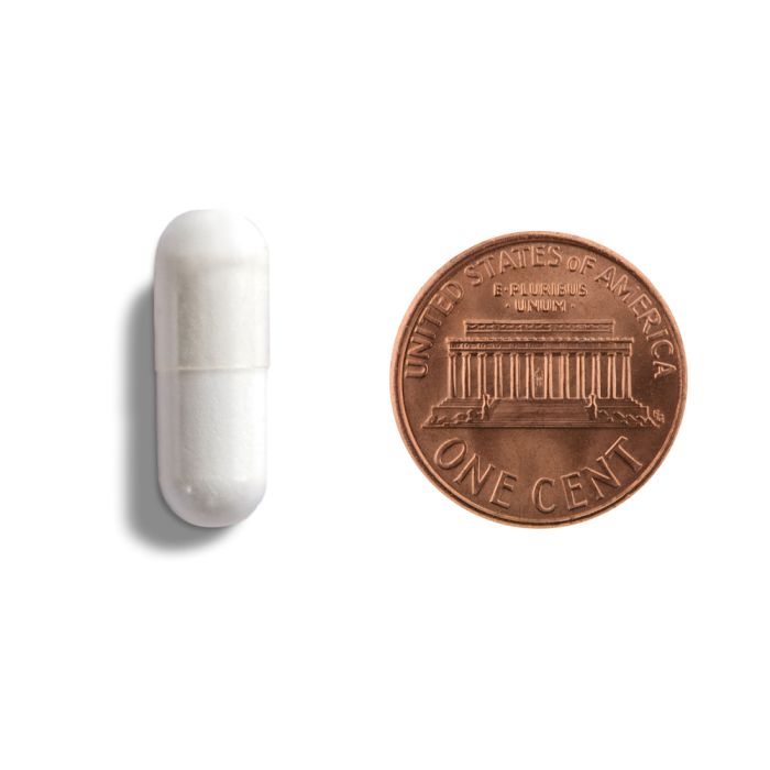 White cylindrical object next to a copper penny on a white background