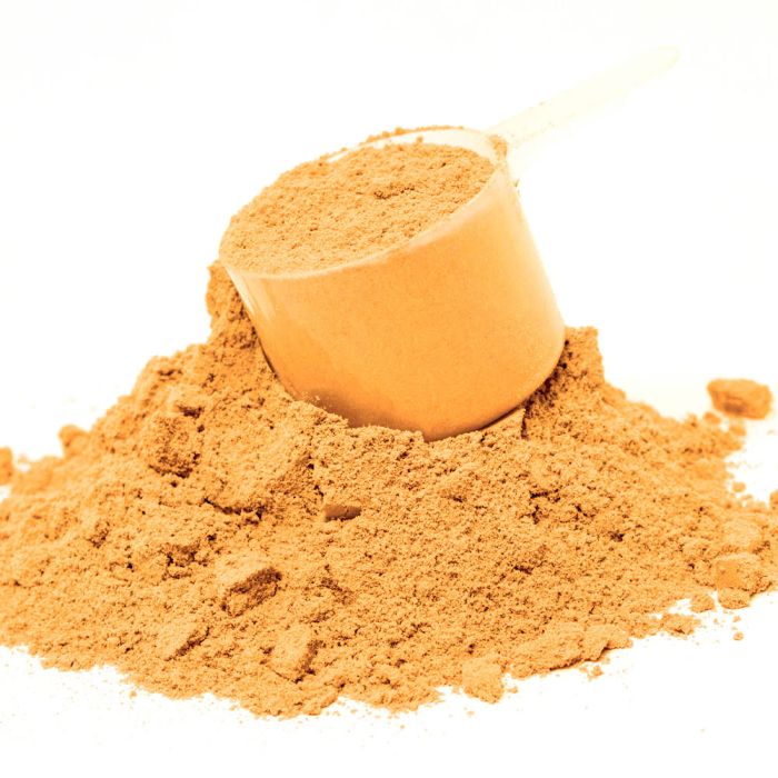 Brown powder with a scoop on a white background