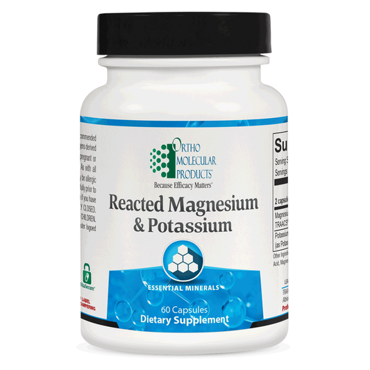 Supplement bottle labeled 'Reacted Magnesium & Potassium' by Ortho Molecular Products on a white background.