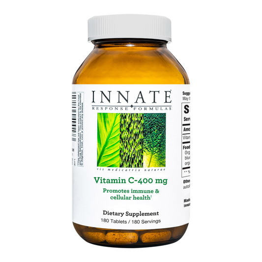 A bottle of Innate Response Vitamin C-400 mg dietary supplement with the label showing the product name and usage information.