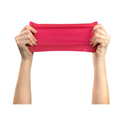 Red resistance band held by hands on a white background