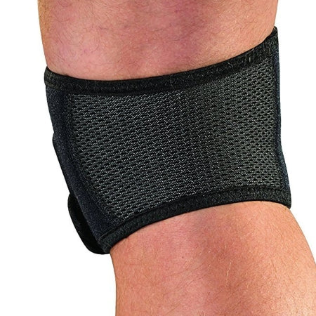 Black knee brace on a person's knee with a white background