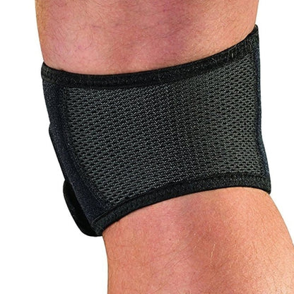 Black knee brace on a person's knee with a white background