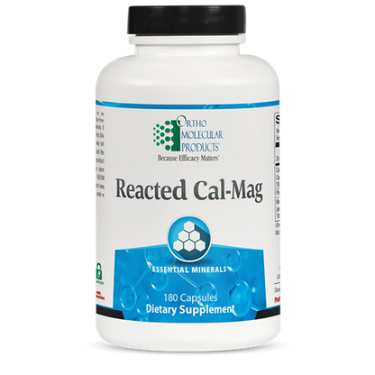 A bottle of OrthoMolecular Products Reacted Cal-Mag dietary supplement with 180 capsules, primarily white in color with blue and green labeling.
