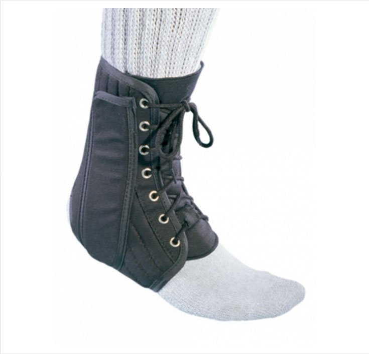 Black ankle support brace worn over a white sock on a white background
