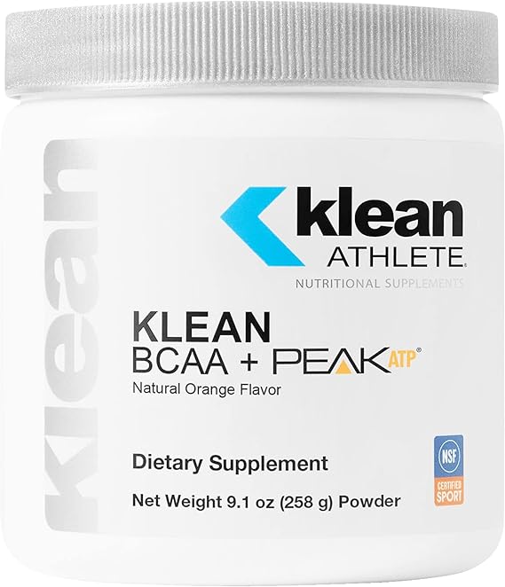 A container of Klean BCAA + Peak ATP dietary supplement in natural orange flavor, indicating it is a powder and has a net weight of 9.1 oz (258 g).