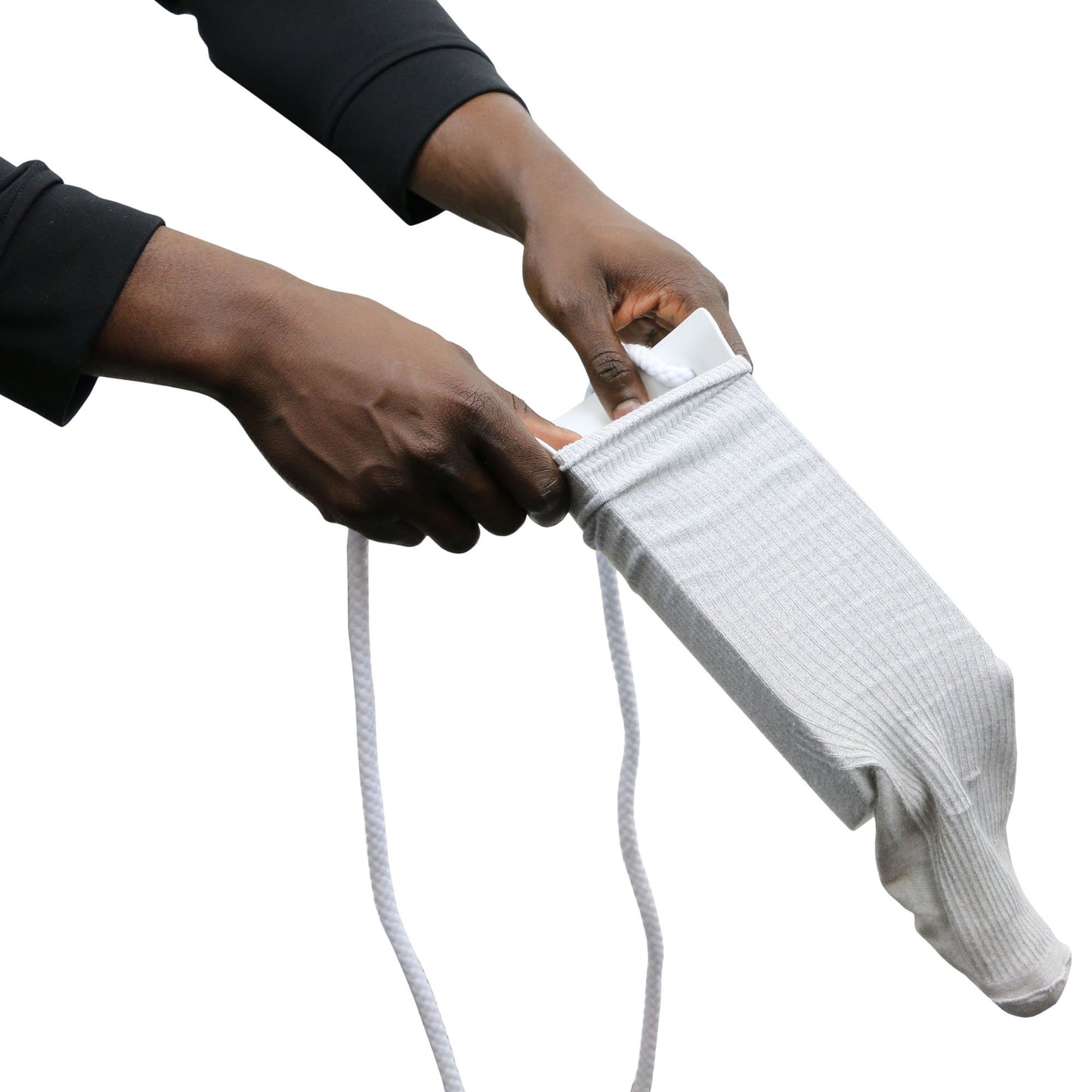 Person holding a white sock with sock aid attached to a rope, on a white background