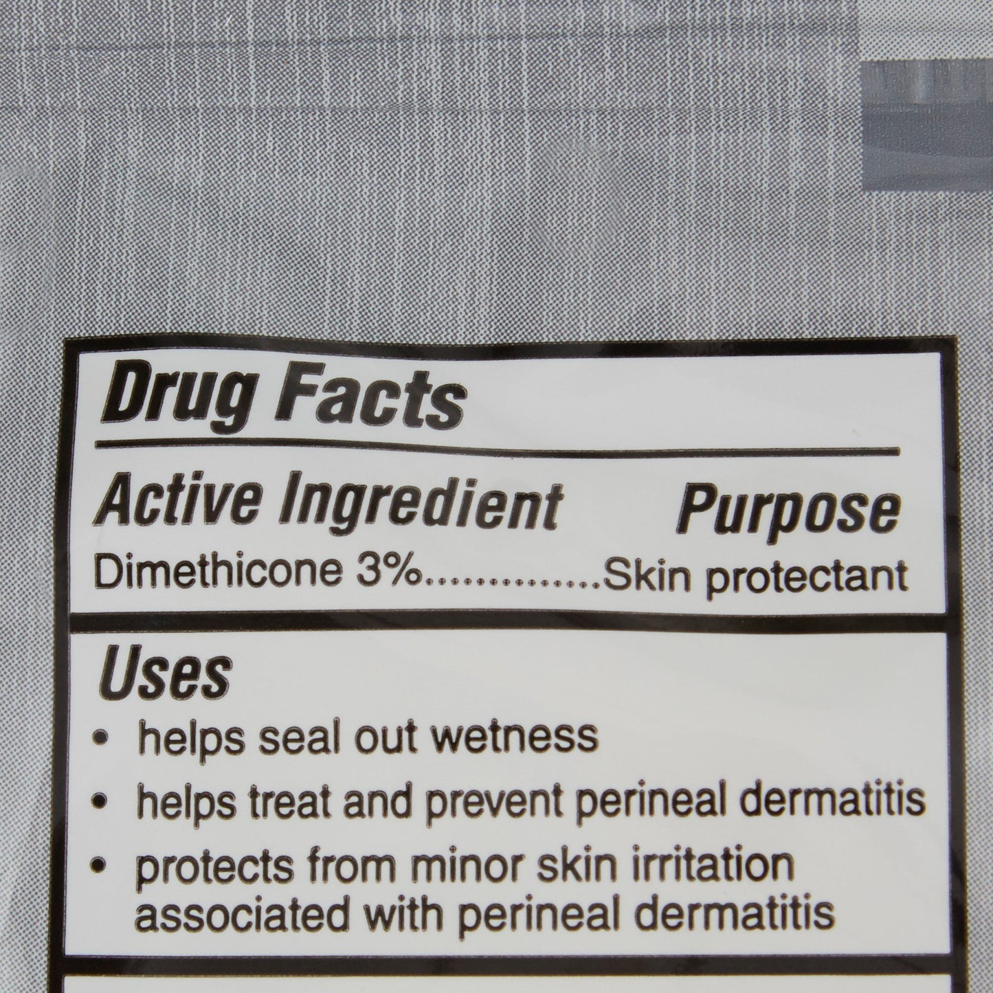 Drug facts label for a skin protectant with active ingredient dimethicone 3% on a gray background.