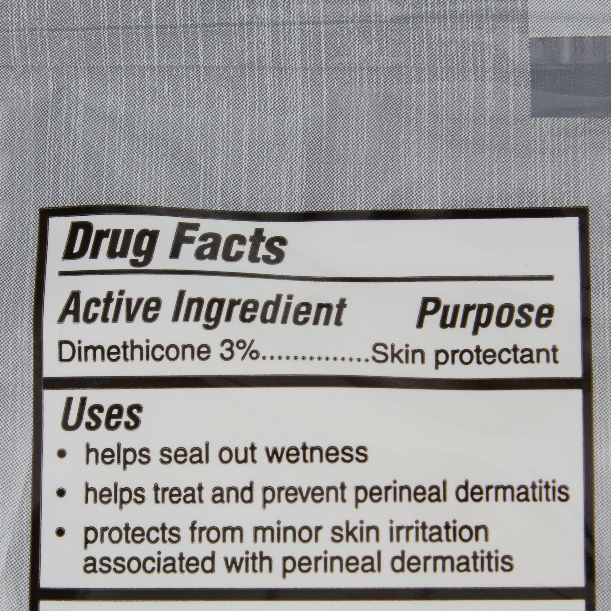 Drug facts label for a skin protectant with active ingredient dimethicone 3% on a gray background.