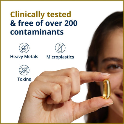 A woman holding a softgel and working that indicates that the sofgel is free of over 200 contaminants