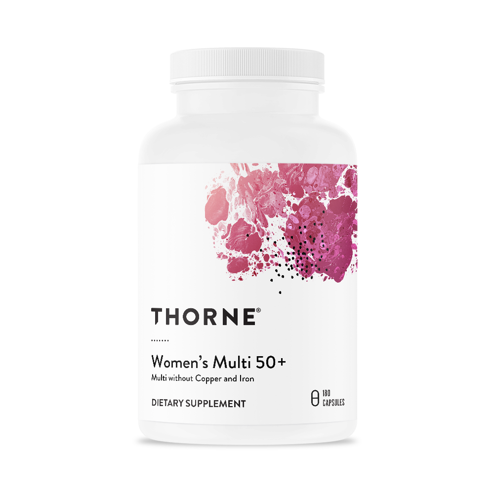A bottle of Thorne Women's Multi 50+ dietary supplement with a white label and pink floral design.