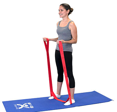 A female demonstrating the use of a red Cando Multgrip exerciser.
