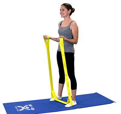A female demonstrating the use of Cando yellow multi-exerciser.  
