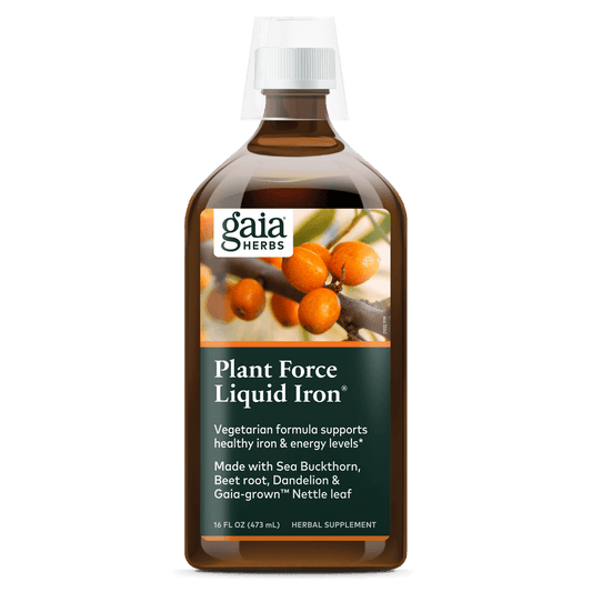 A bottle of Gaia Plant Force Liquid Iron supplement with a label showing the brand name, product name, and images of plants. The bottle is 16 oz in size.