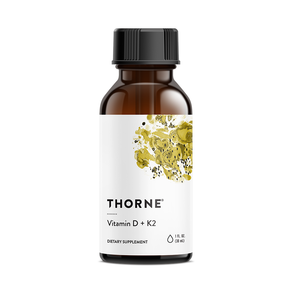 A bottle of Thorne Vitamin D + K2 Liquid supplement with a white label and yellow accents.