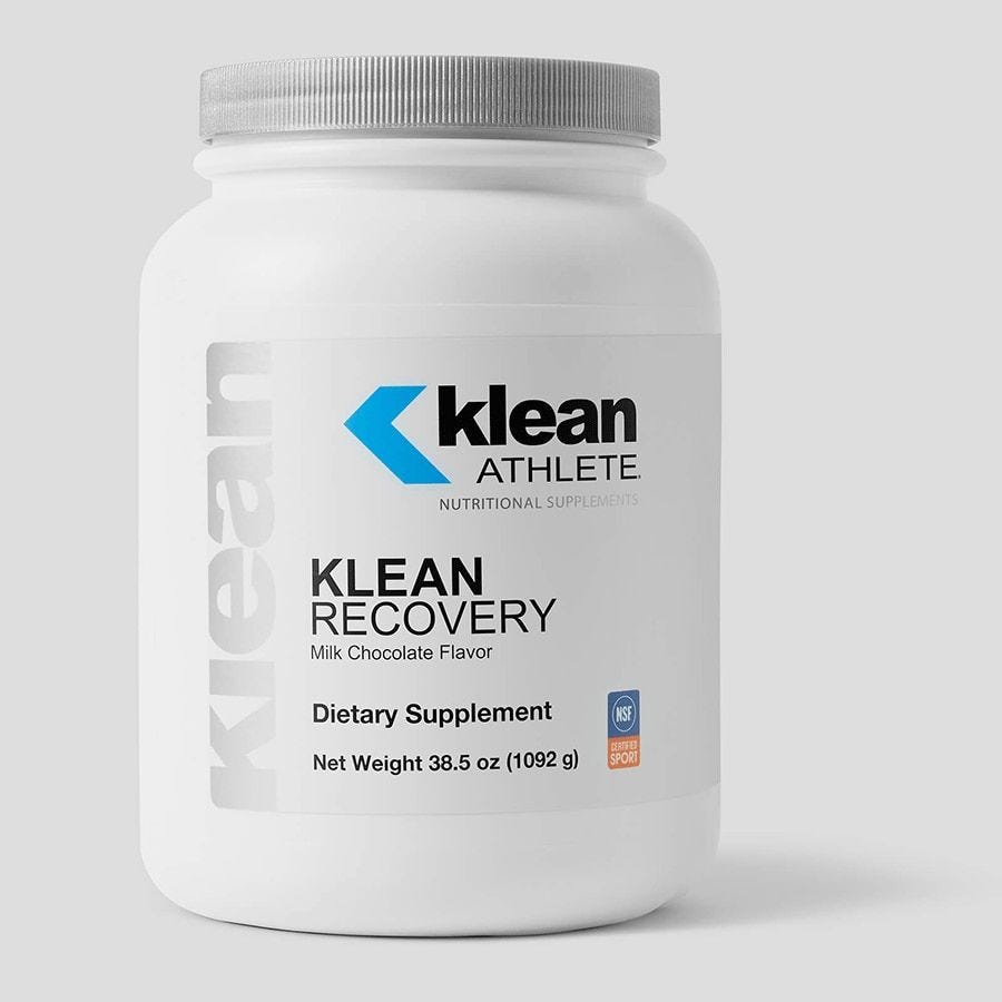 A white plastic jar with a blue and grey label that reads 'Klean Recovery', Milk Chocolate Flavor, and indicates it is a dietary supplement.