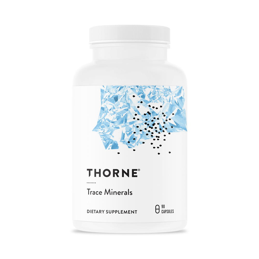 A white bottle with a blue pattern labeled 'THORNE Trace Minerals', containing dietary supplement capsules.