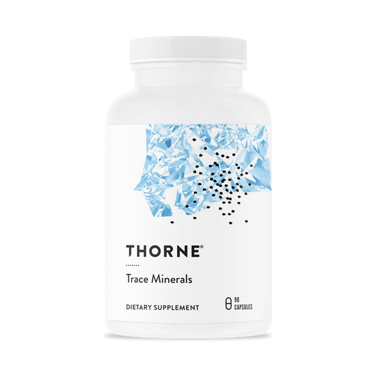 A white bottle with a blue pattern labeled 'THORNE Trace Minerals', containing dietary supplement capsules.