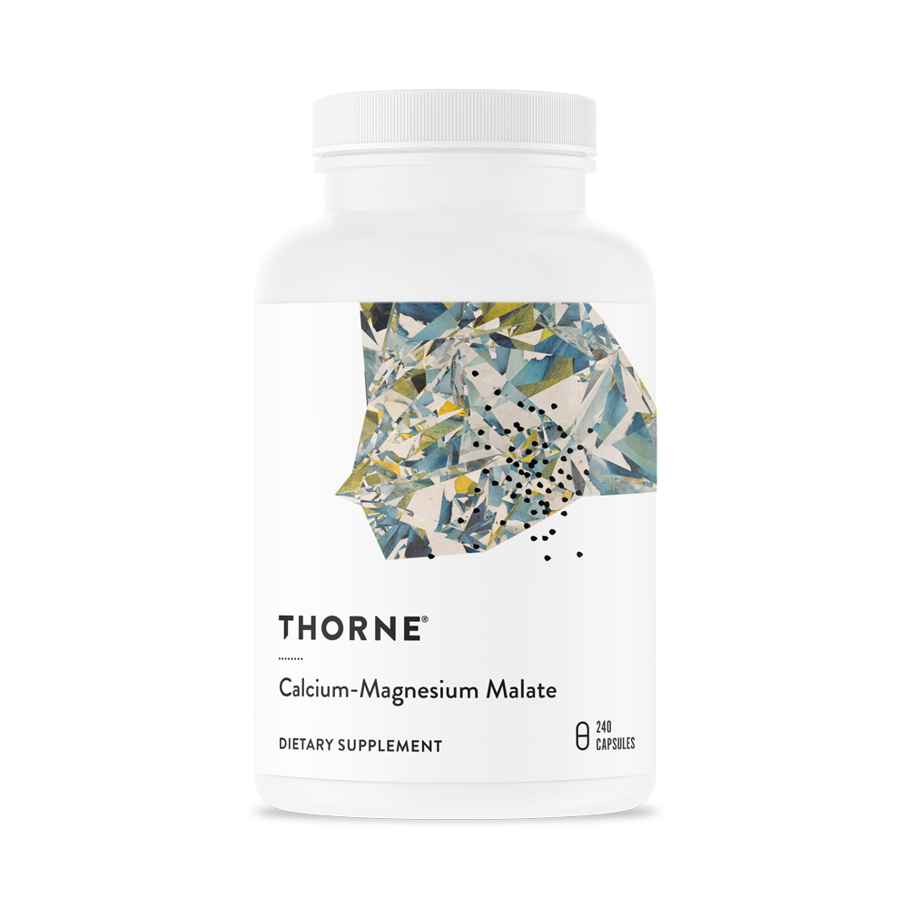 A bottle of Thorne Calcium-Magnesium Malate dietary supplement with a floral design on the label.