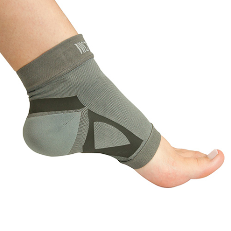 Gray ankle support brace on a person's foot against a white background