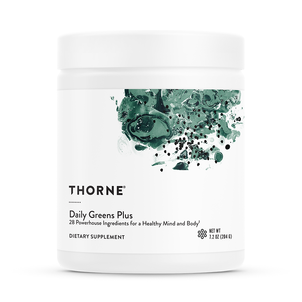 A container of Thorne Daily Greens Plus dietary supplement with a green leaf design on the label.