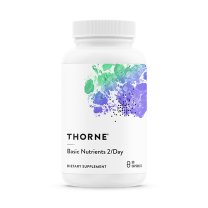 A bottle of Thorne Basic Nutrients 2/Day dietary supplement with a white label and a purple and green watercolor design.
